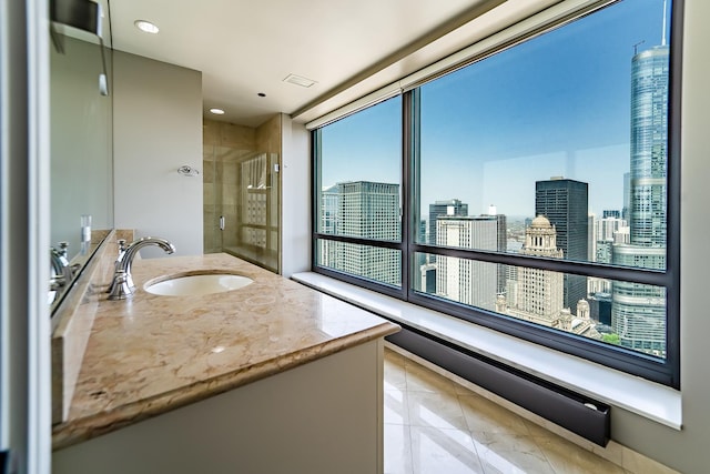 bathroom featuring vanity, tile patterned floors, and tiled shower