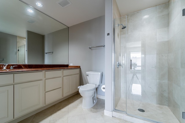 bathroom featuring an enclosed shower, vanity, tile patterned floors, and toilet