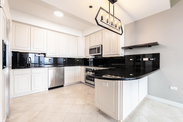 kitchen with light tile patterned floors, appliances with stainless steel finishes, decorative light fixtures, white cabinets, and sink