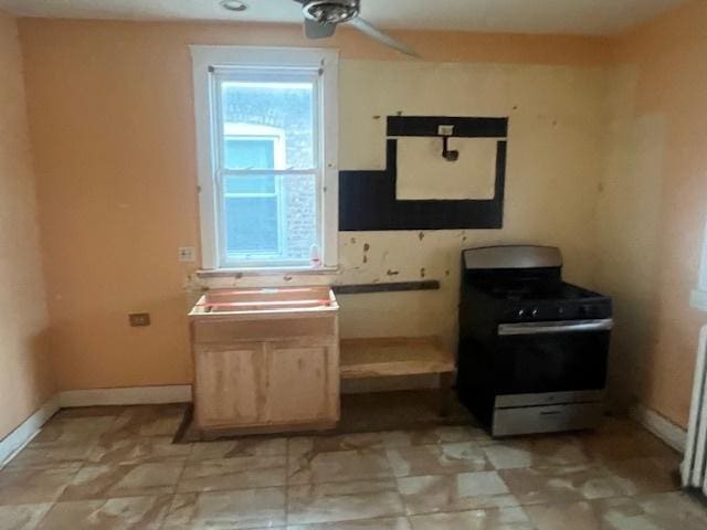 kitchen featuring stainless steel range with gas stovetop and light brown cabinets