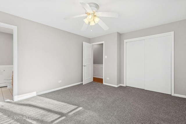 unfurnished bedroom featuring light carpet, ceiling fan, a closet, and connected bathroom