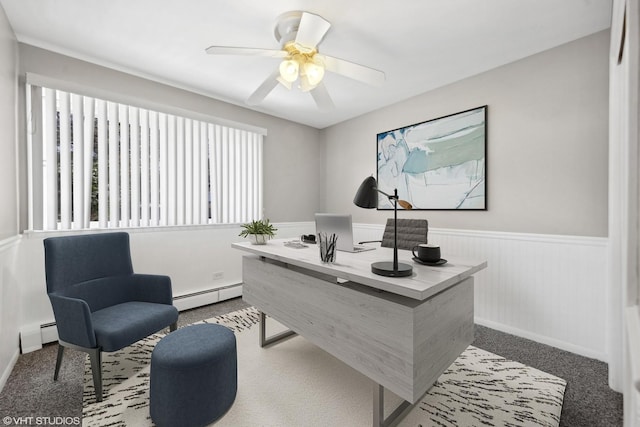 carpeted home office featuring ceiling fan and baseboard heating