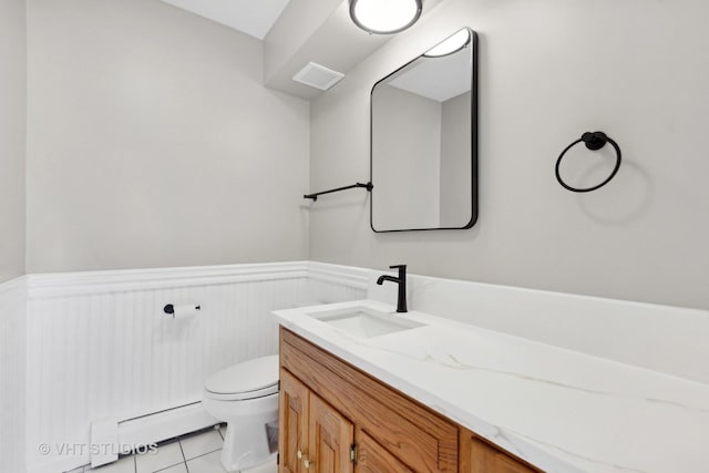 bathroom featuring toilet, vanity, tile patterned floors, and a baseboard radiator