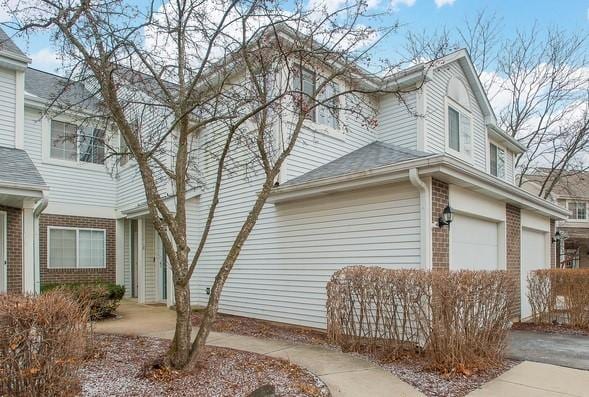 view of side of home featuring a garage