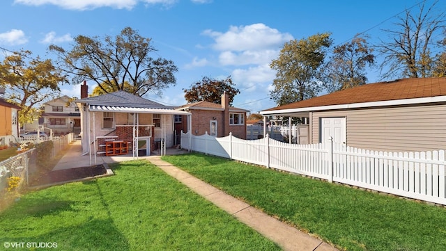 back of property featuring a lawn and a patio area