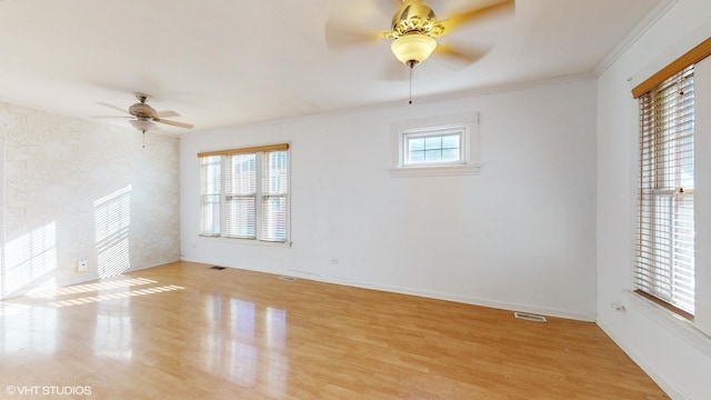 spare room with ceiling fan, crown molding, and light hardwood / wood-style flooring