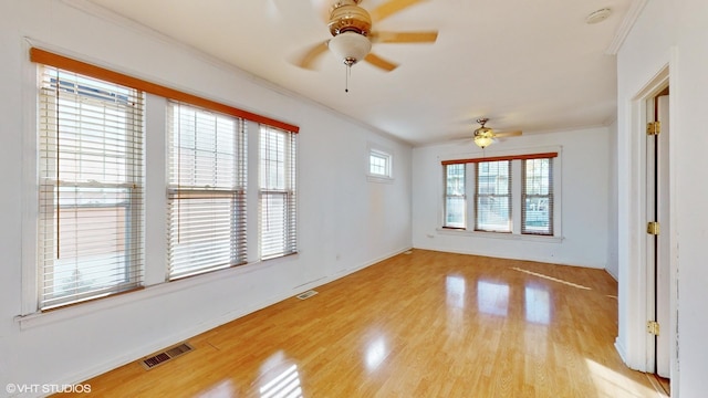 unfurnished room with ceiling fan, crown molding, and light hardwood / wood-style floors