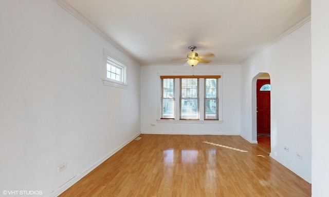 empty room featuring light wood-type flooring, ceiling fan, and ornamental molding