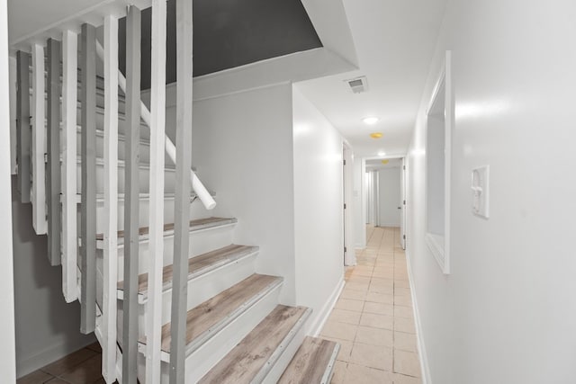 staircase featuring tile patterned floors