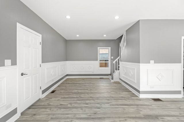 unfurnished room with light wood-type flooring