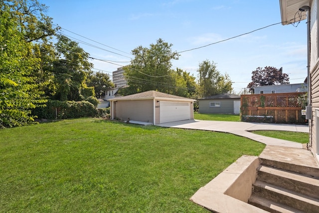 view of yard featuring a garage and an outdoor structure