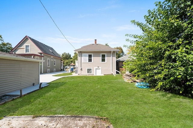 rear view of property with a lawn