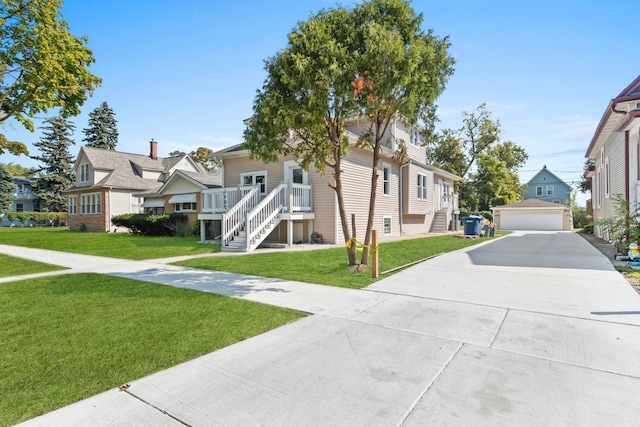 view of front of house with a garage, a front lawn, and an outdoor structure