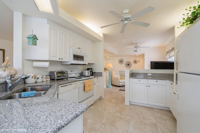 kitchen featuring white appliances, ceiling fan, white cabinets, and sink