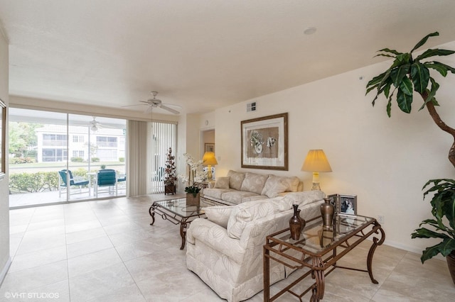 living room featuring ceiling fan and light tile patterned floors