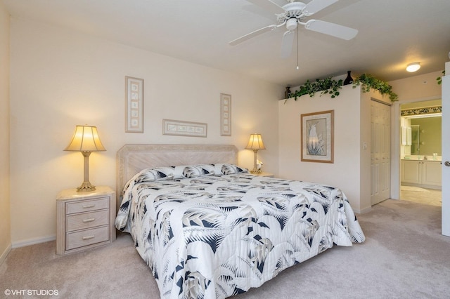 carpeted bedroom with ceiling fan and connected bathroom