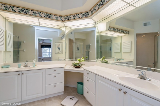 bathroom featuring a shower with shower door, tile patterned floors, and vanity