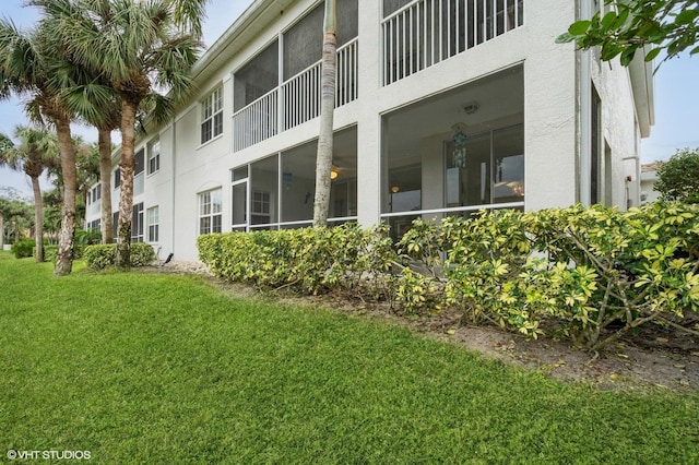 view of side of home featuring a lawn