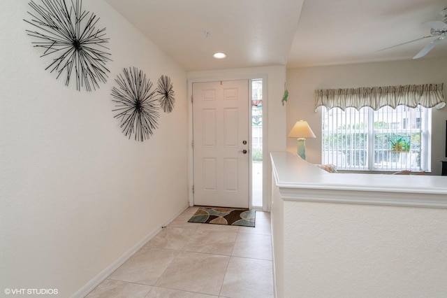 entryway featuring ceiling fan and light tile patterned flooring