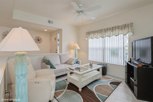 living room with ceiling fan and light tile patterned floors