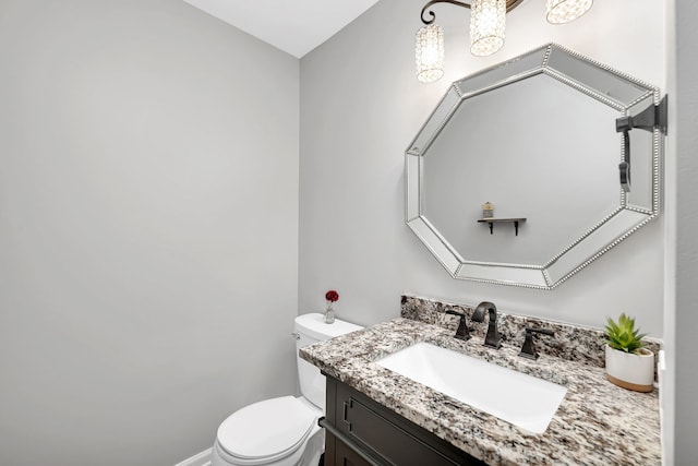 bathroom with toilet and vanity