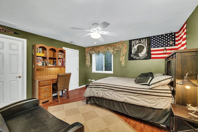 bedroom with ceiling fan and hardwood / wood-style flooring