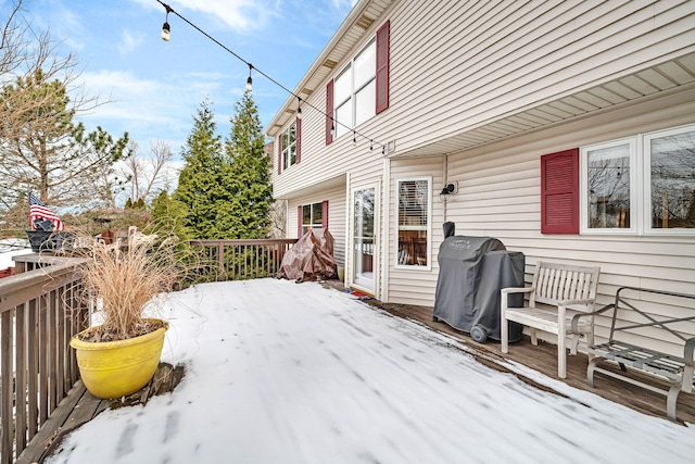 snow covered deck featuring area for grilling