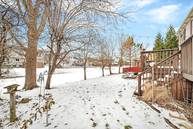 yard covered in snow featuring a playground