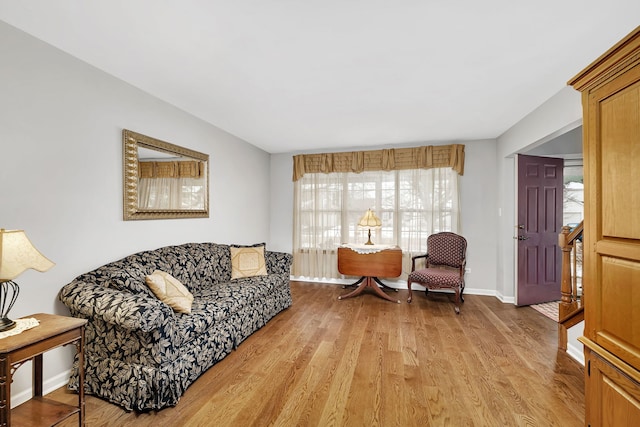 living room featuring a wealth of natural light and light hardwood / wood-style flooring