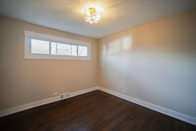 unfurnished room featuring dark wood-type flooring