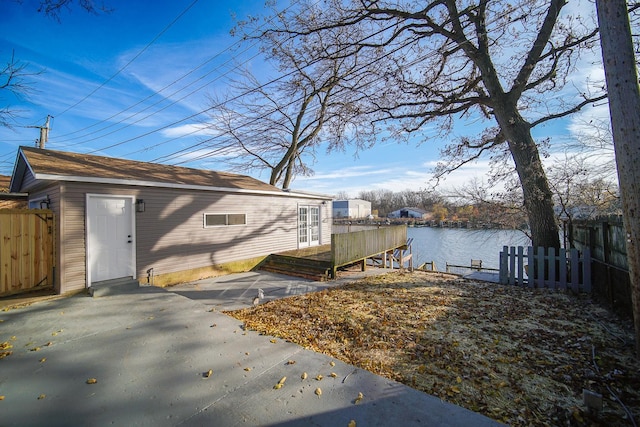 view of side of property with a water view and a patio area