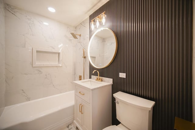 full bathroom with tiled shower / bath, vanity, and toilet