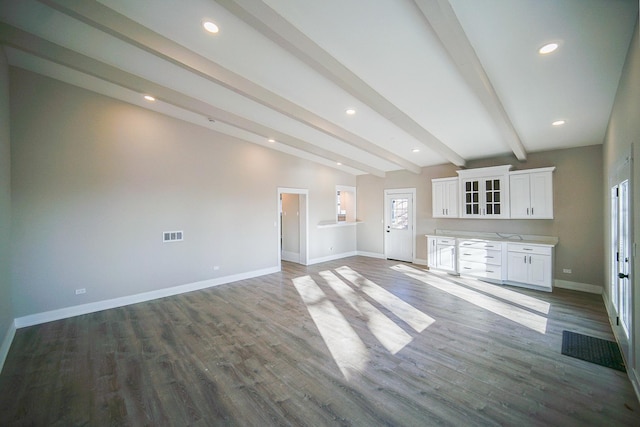 unfurnished living room with hardwood / wood-style floors and lofted ceiling with beams