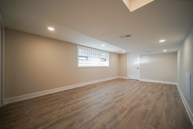 basement with dark hardwood / wood-style floors