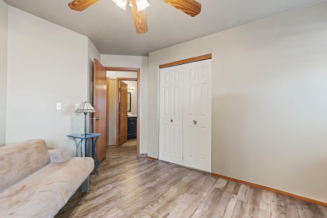 living area featuring hardwood / wood-style flooring and ceiling fan