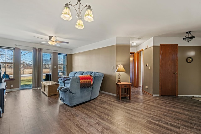 living room with dark hardwood / wood-style floors and ceiling fan