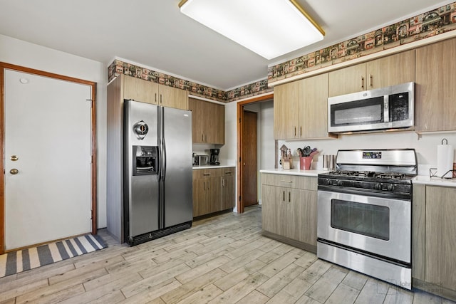 kitchen featuring light wood-type flooring and appliances with stainless steel finishes