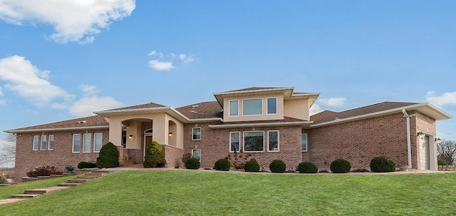 view of front of home with a garage and a front lawn