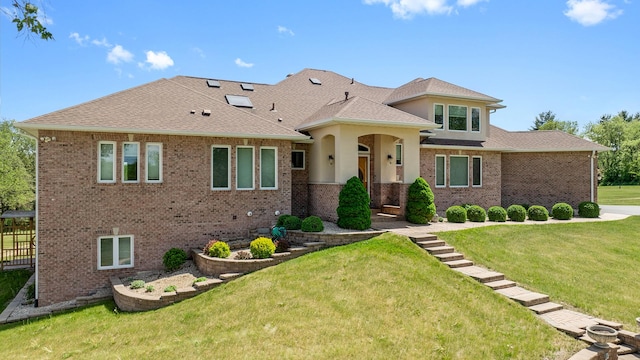 14481 Berglund Rd, Pecatonica, IL 61063 - view of front facade featuring a front lawn, brick siding, and roof with shingles