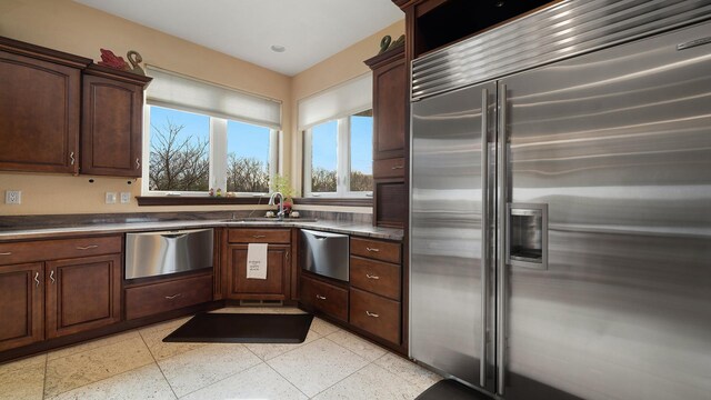 14481 Berglund Rd, Pecatonica, IL 61063 - kitchen featuring appliances with stainless steel finishes, a sink, dark aggregate flooring, dark countertops, and dark brown cabinets
