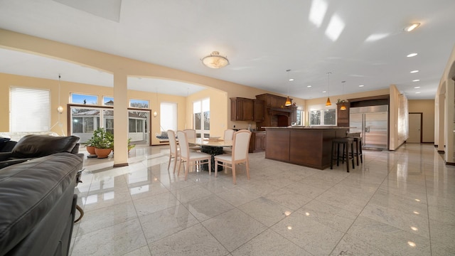14481 Berglund Rd, Pecatonica, IL 61063 - dining space with arched walkways, plenty of natural light, and recessed lighting