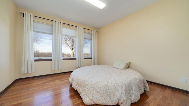 14481 Berglund Rd, Pecatonica, IL 61063 - bedroom with wood finished floors, baseboards, and lofted ceiling