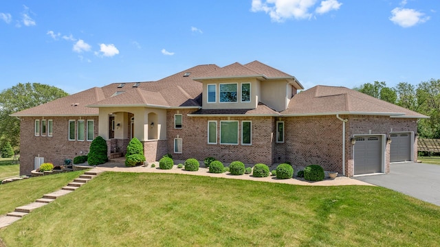 14481 Berglund Rd, Pecatonica, IL 61063 - view of front of property featuring a front lawn, a garage, driveway, and brick siding
