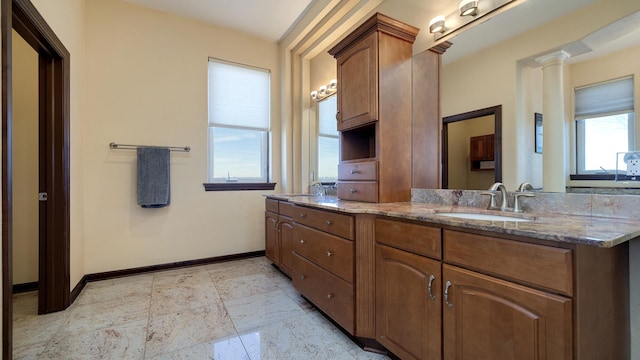 bathroom featuring vanity and ornate columns