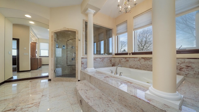 bathroom featuring ornate columns, separate shower and tub, and an inviting chandelier