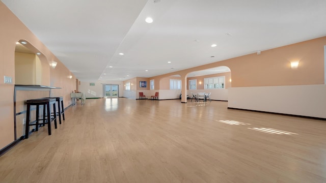 14481 Berglund Rd, Pecatonica, IL 61063 - unfurnished living room featuring light wood finished floors, recessed lighting, arched walkways, and baseboards