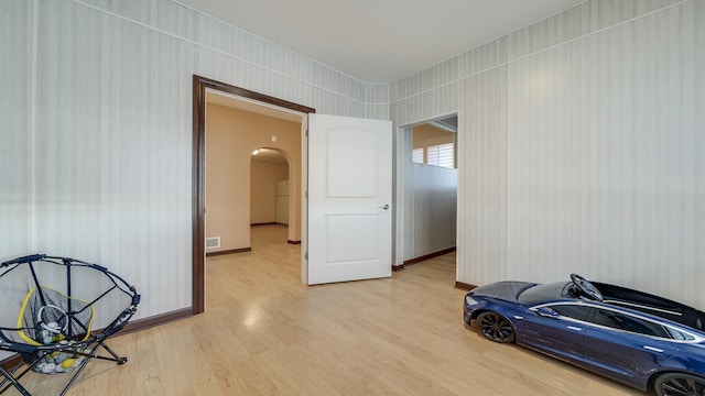 unfurnished room with wood-type flooring