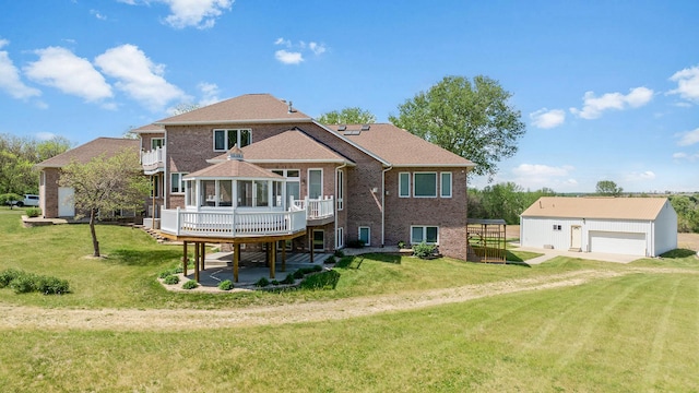 14481 Berglund Rd, Pecatonica, IL 61063 - back of property with a wooden deck, brick siding, an outdoor structure, and a yard
