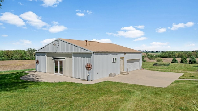 14481 Berglund Rd, Pecatonica, IL 61063 - rear view of property with a detached garage, a yard, an outbuilding, and metal roof
