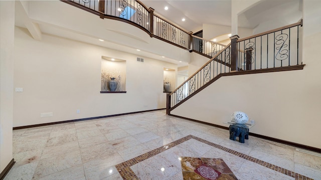 14481 Berglund Rd, Pecatonica, IL 61063 - unfurnished living room with inlaid floor details, baseboards, a towering ceiling, stairs, and recessed lighting